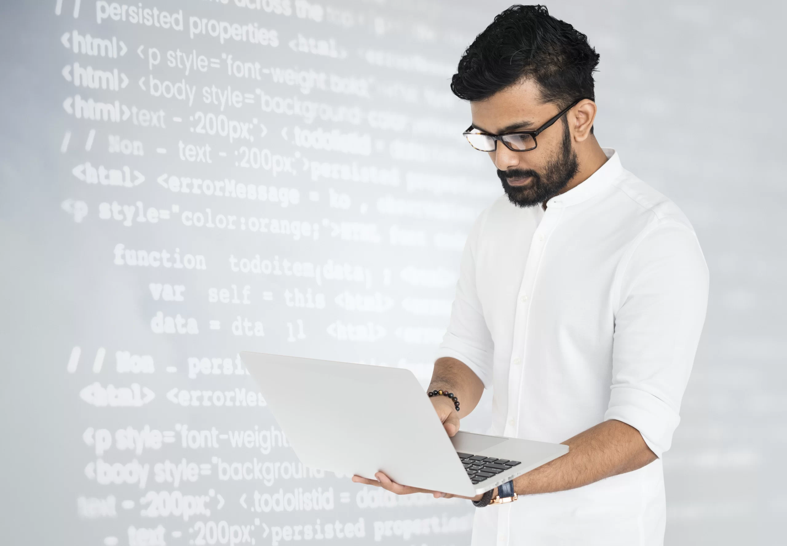 hacker-using-laptop Person using a laptop with user interface (UI) and user experience (UX) design elements displayed on the screen